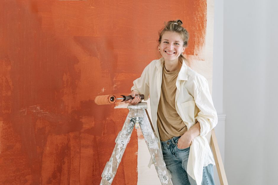 Painter rolling fresh paint onto an interior wall