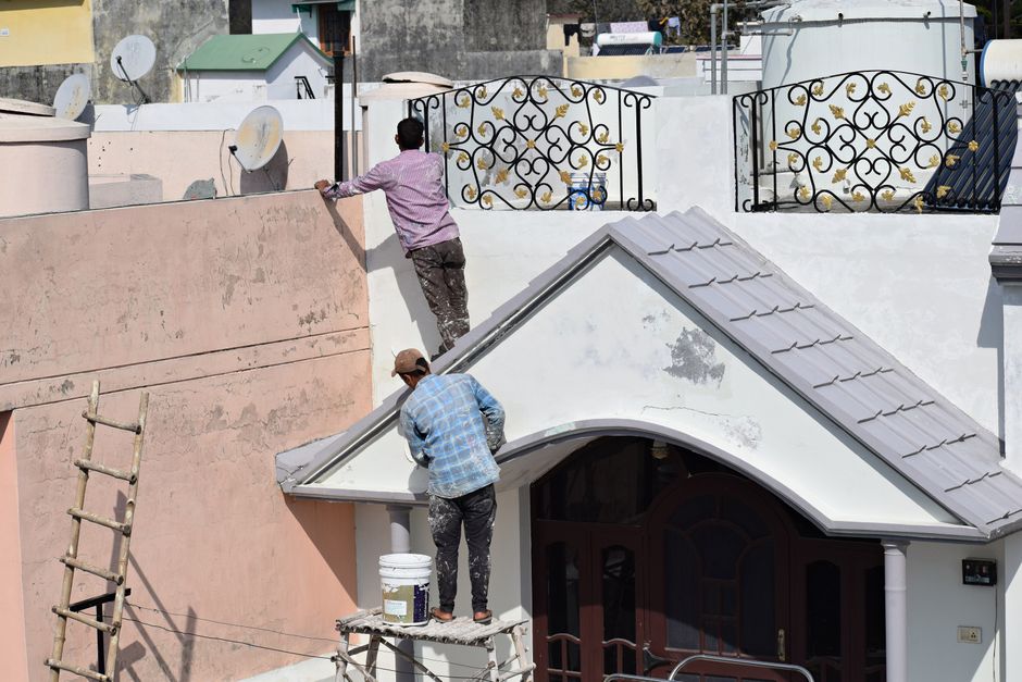 Exterior house painting from a ladder